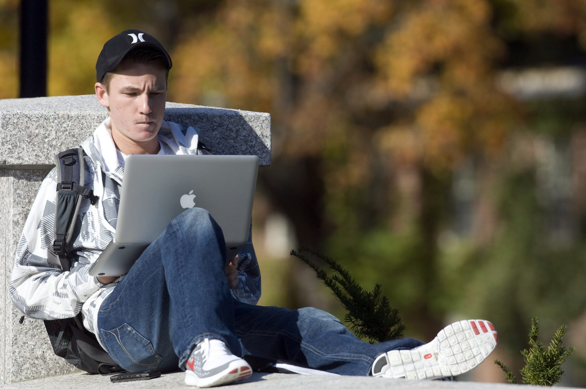 student studying on laptop outside