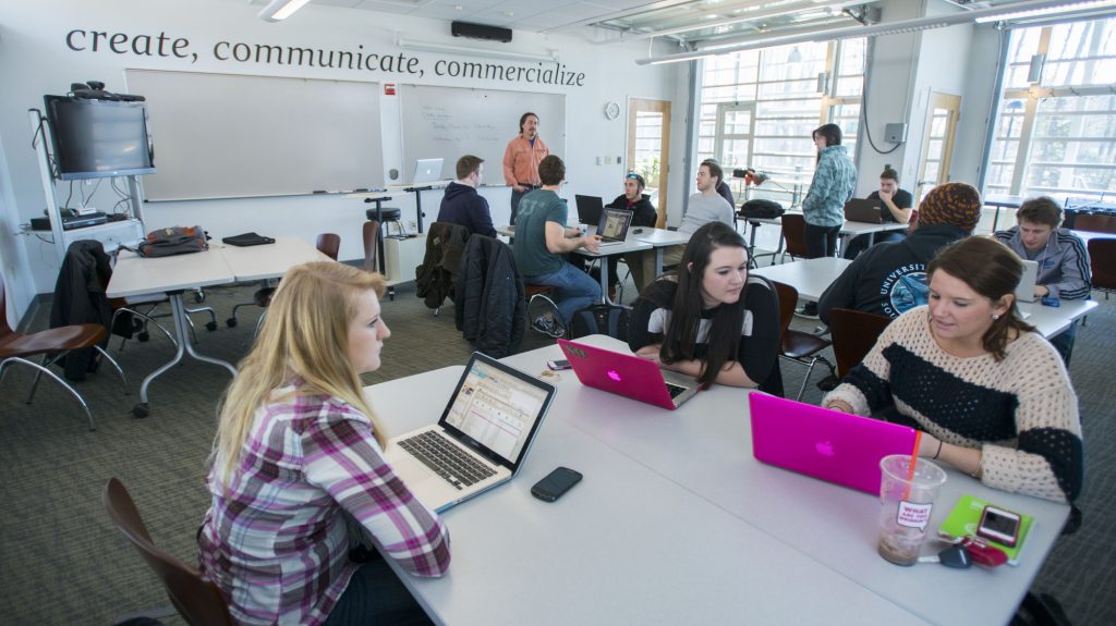 students on laptops in classroom