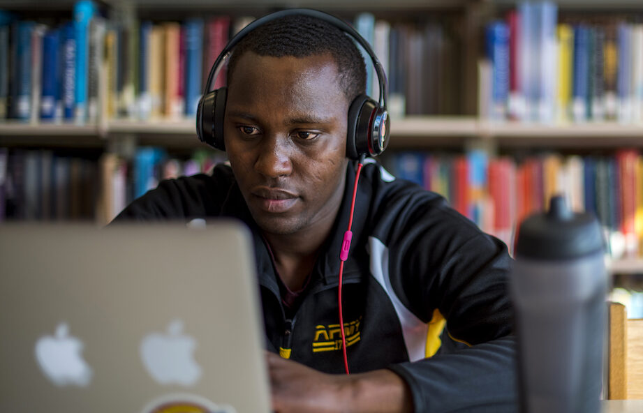 student studying in library with headphones