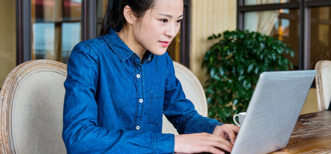 Beautiful young businesswoman working with laptop at office.