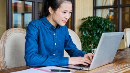 Beautiful young businesswoman working with laptop at office.