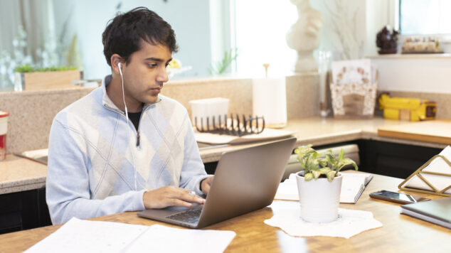 Student working on a laptop at home