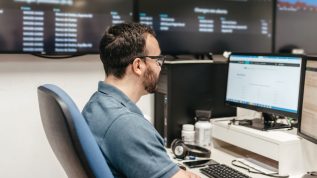 man checking business data on screen in office