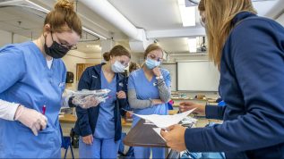 Nursing students working in a lab.