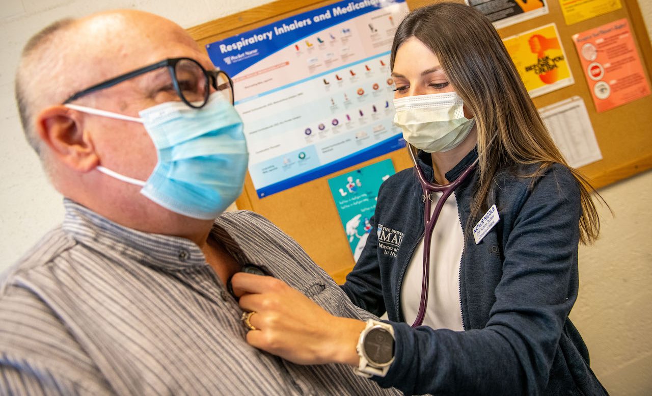 Nursing student working with a patient.