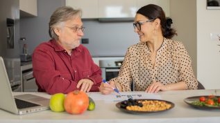 Nutritionist creating a meal plan with a client