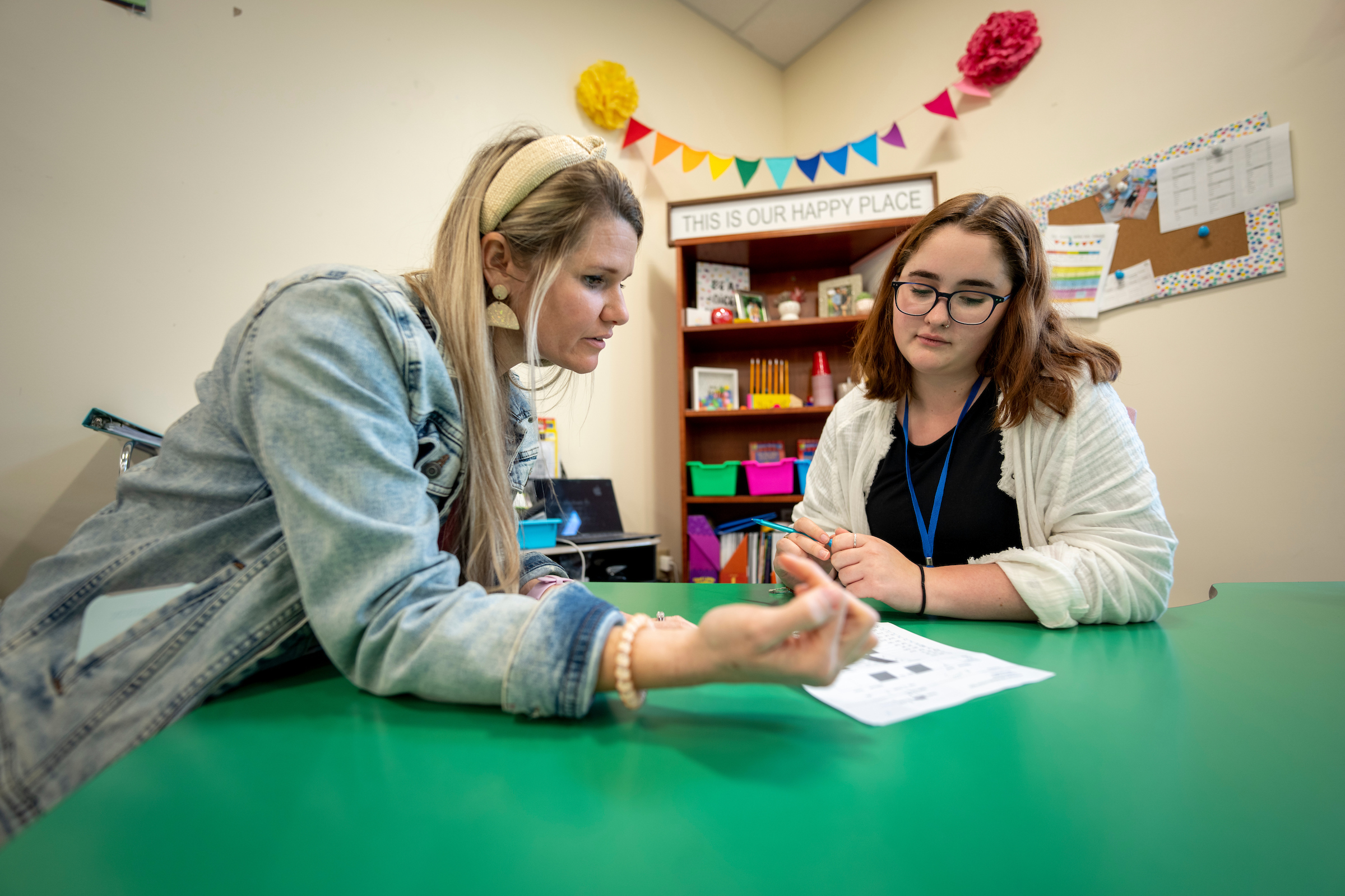 Two teachers talking in a classroom