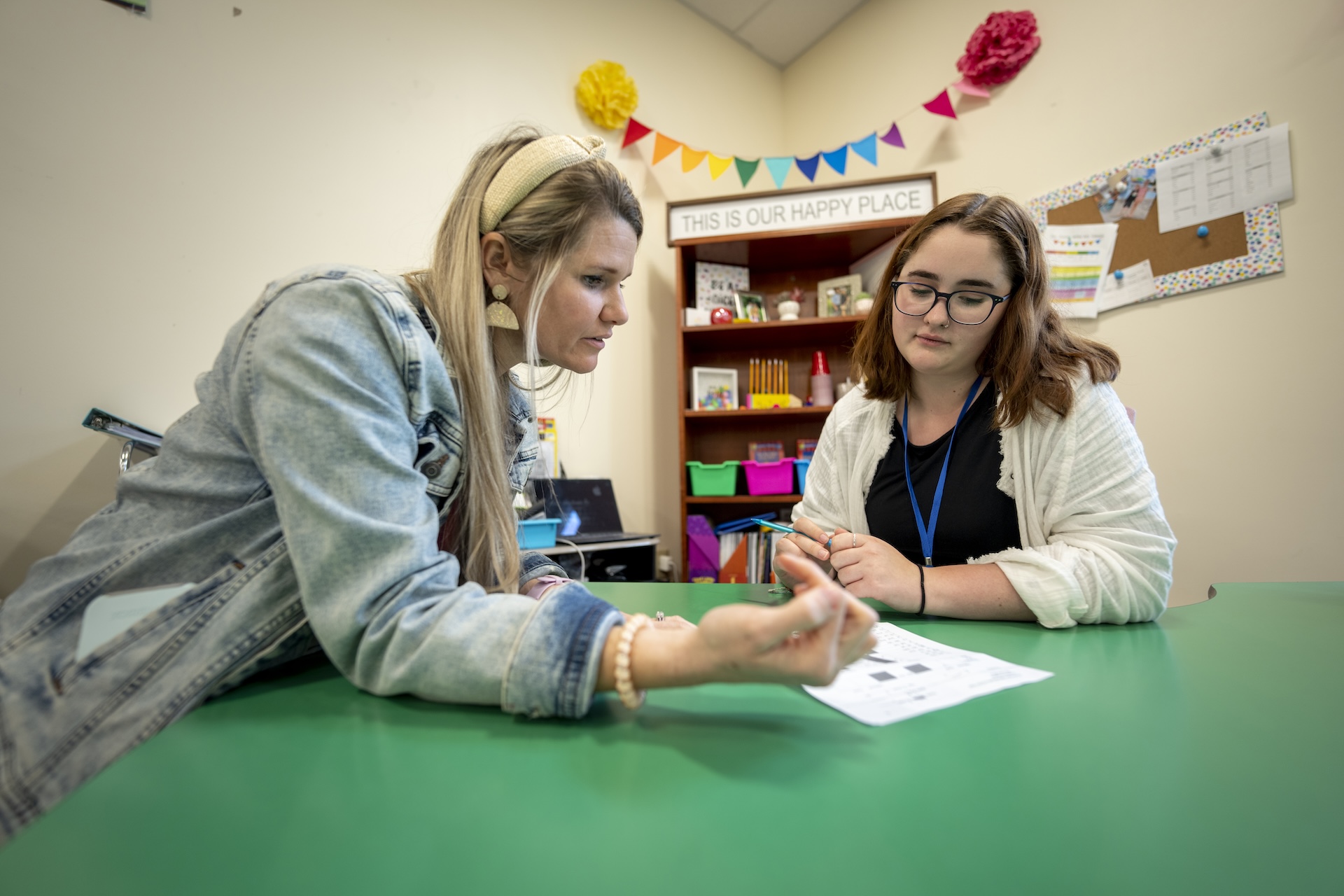 Two teachers talking in a classroom