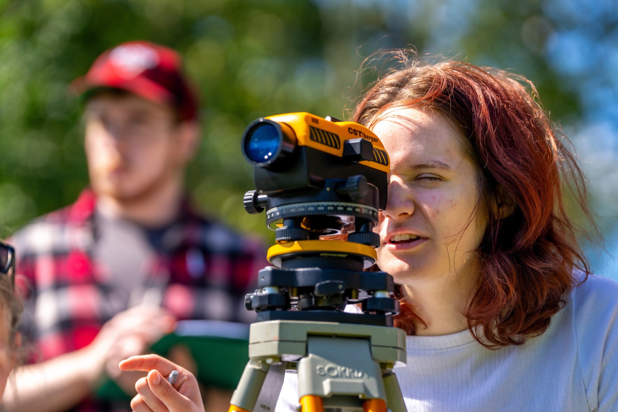 Student using surveying equipment