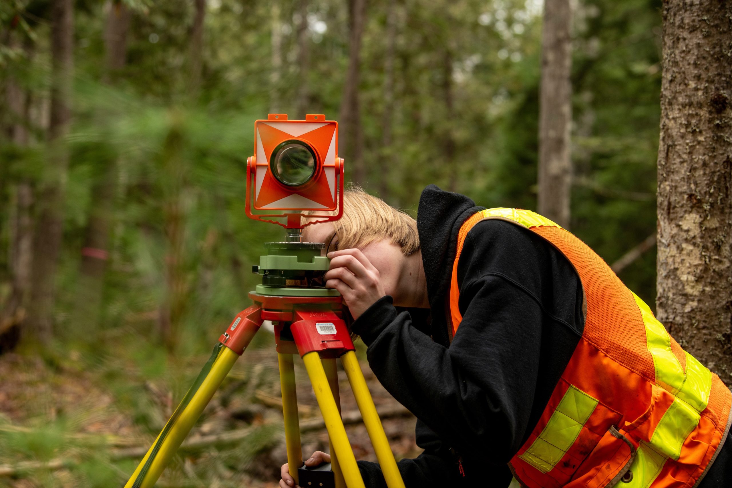 Student using land surveying equipment.