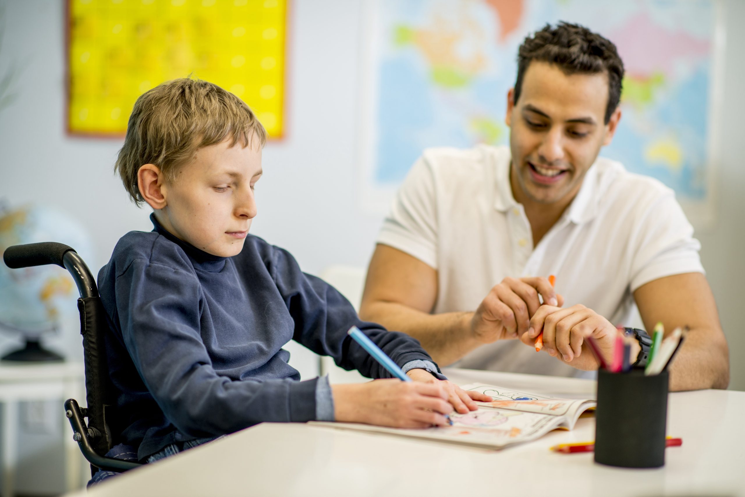 Teacher working with student with disabilities