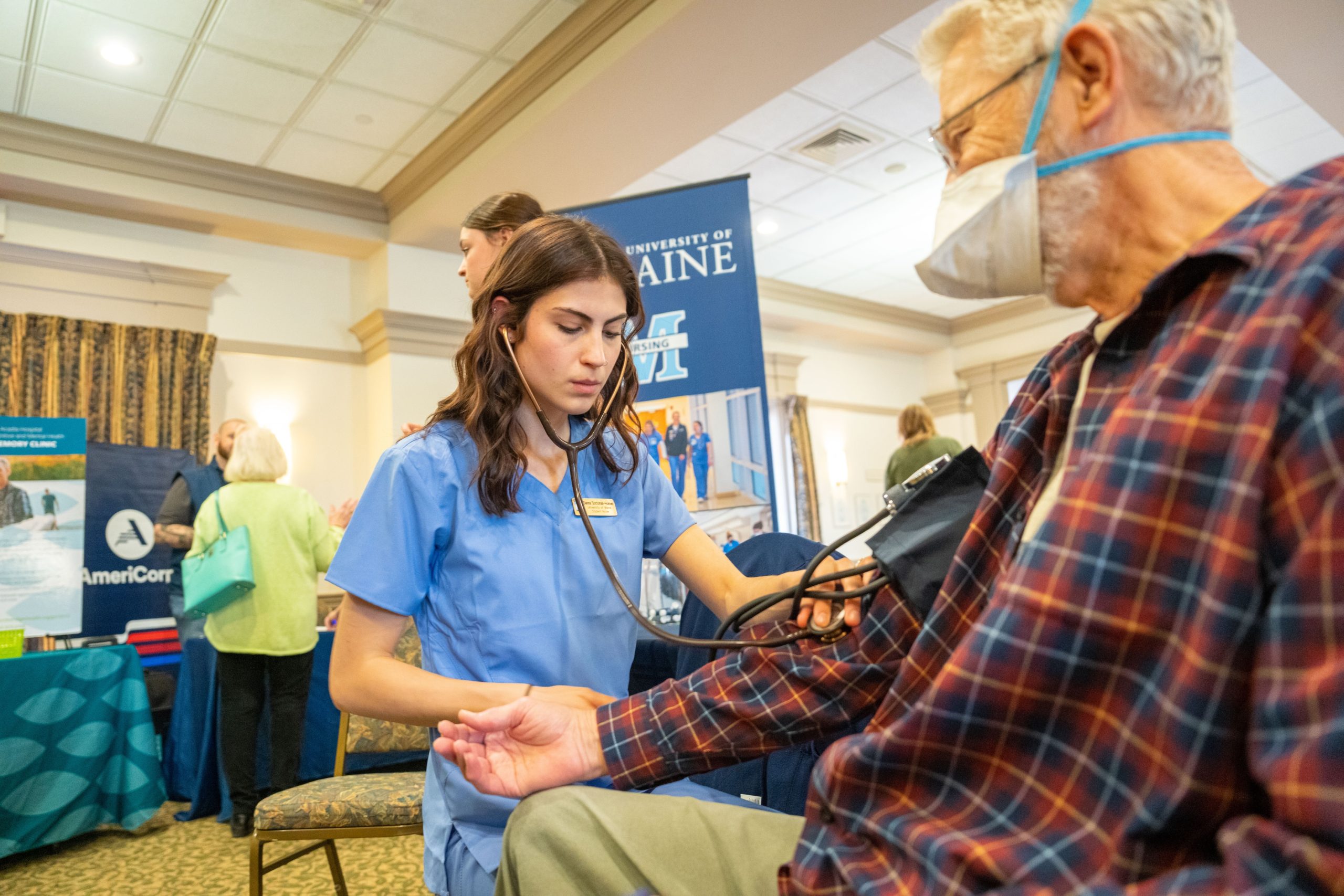 Nurse taking blood pressure of elderly patient