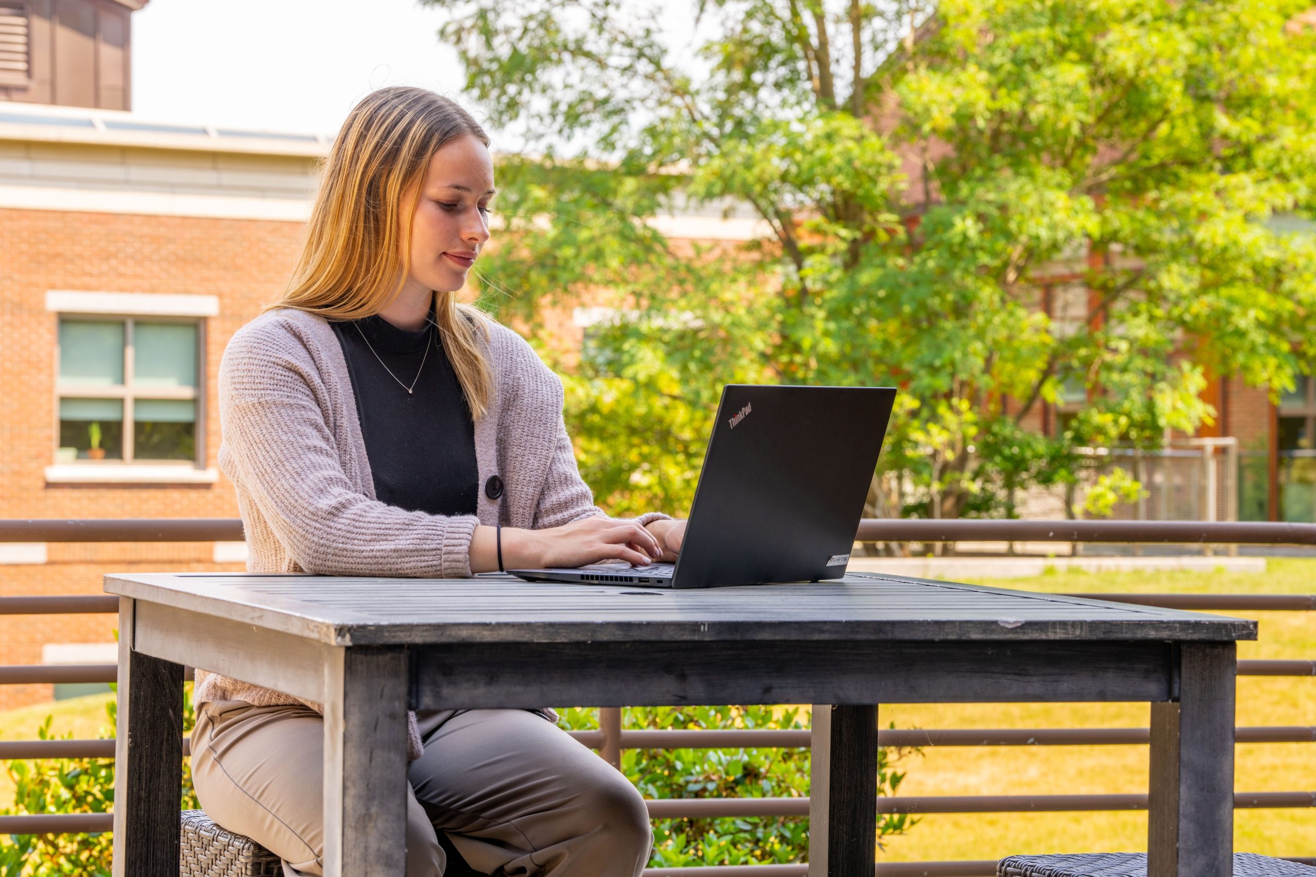 Student working on a laptop outdoors