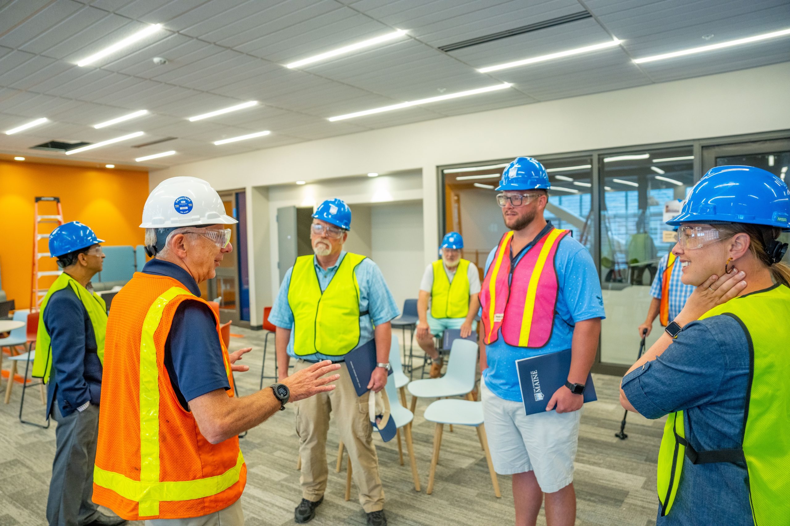 A group of business people in hardhats