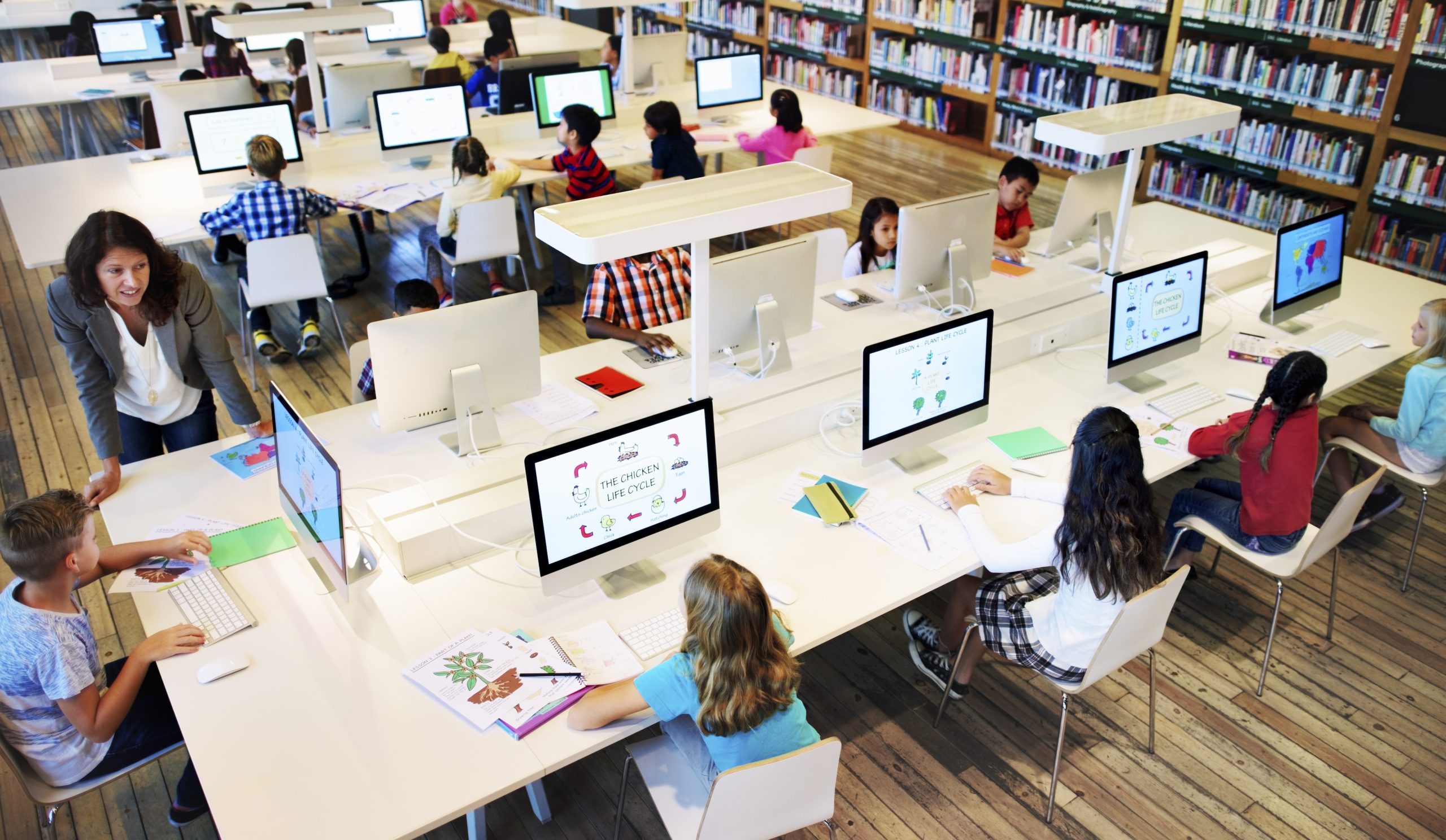 Teacher with students in a computer lab