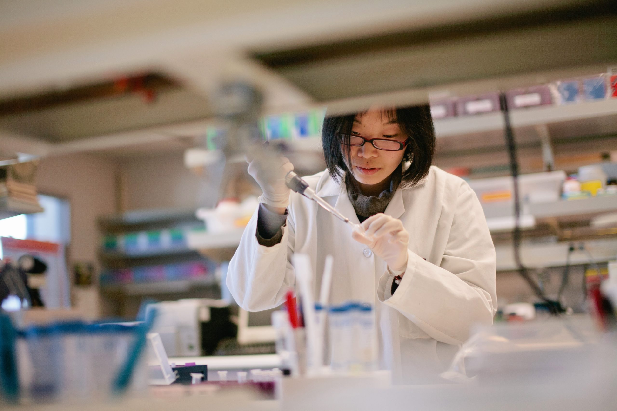 Student putting samples into a test tube