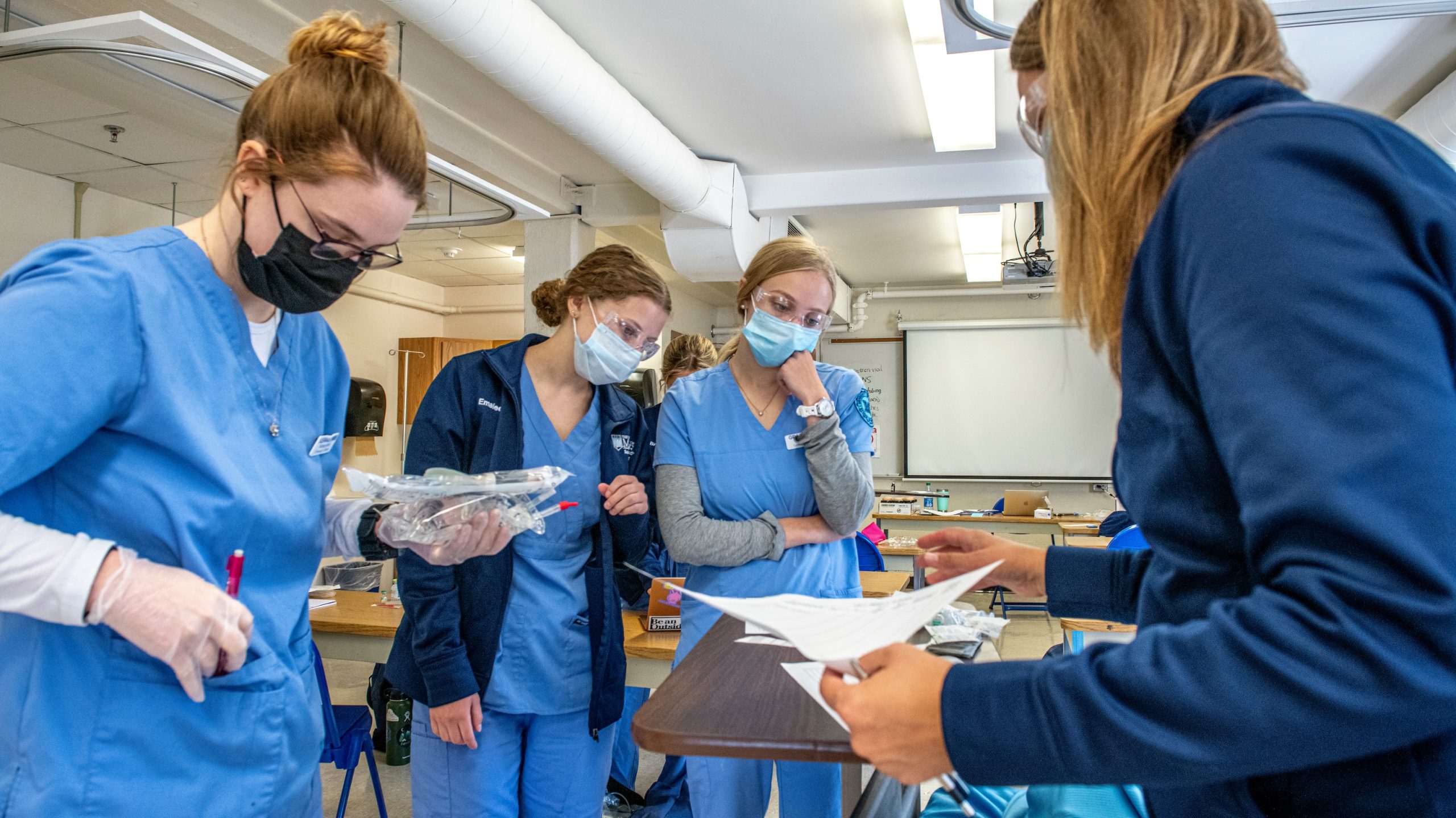 Nursing students working in a lab.