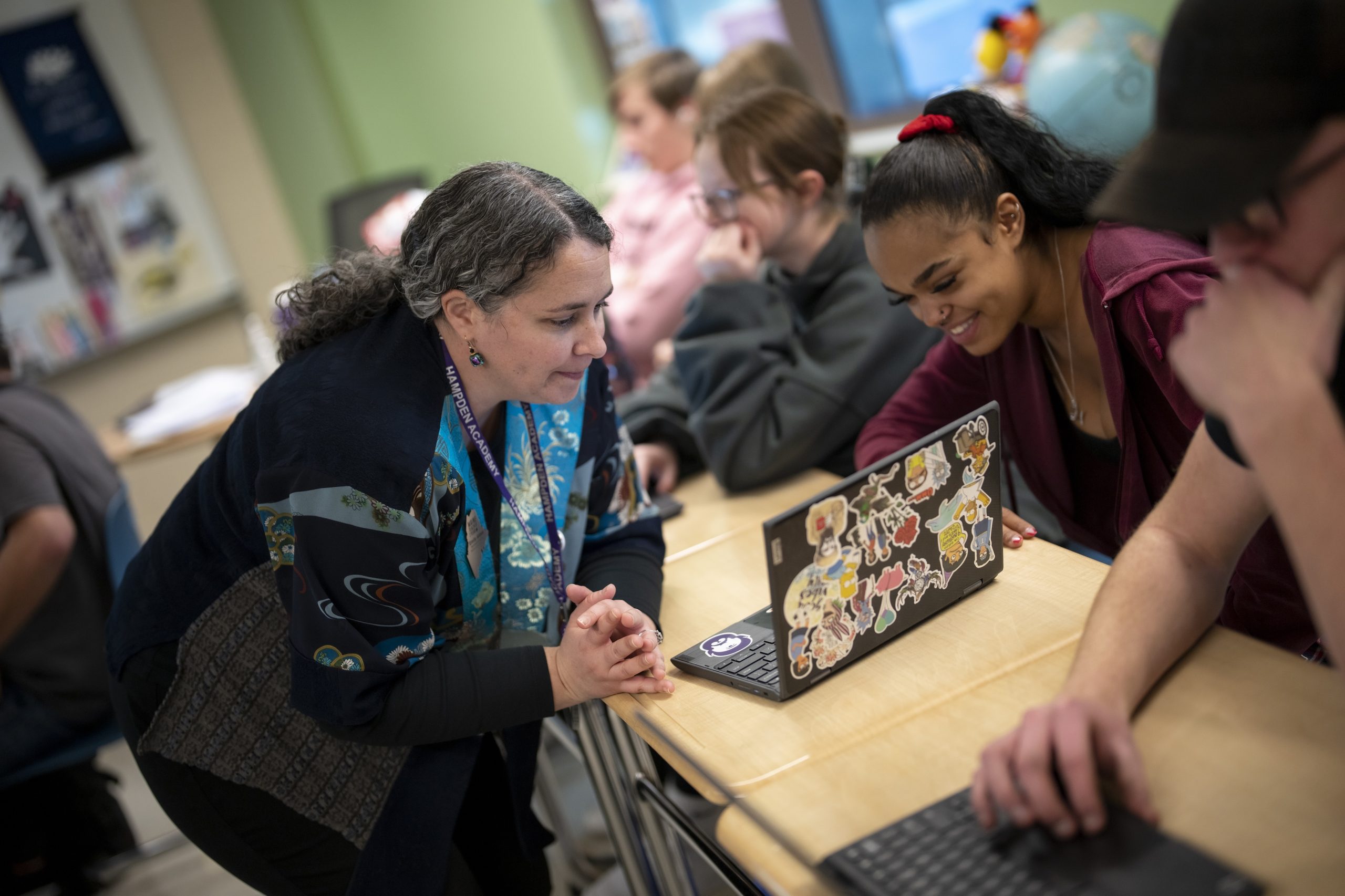 Teacher working with student in a classroom