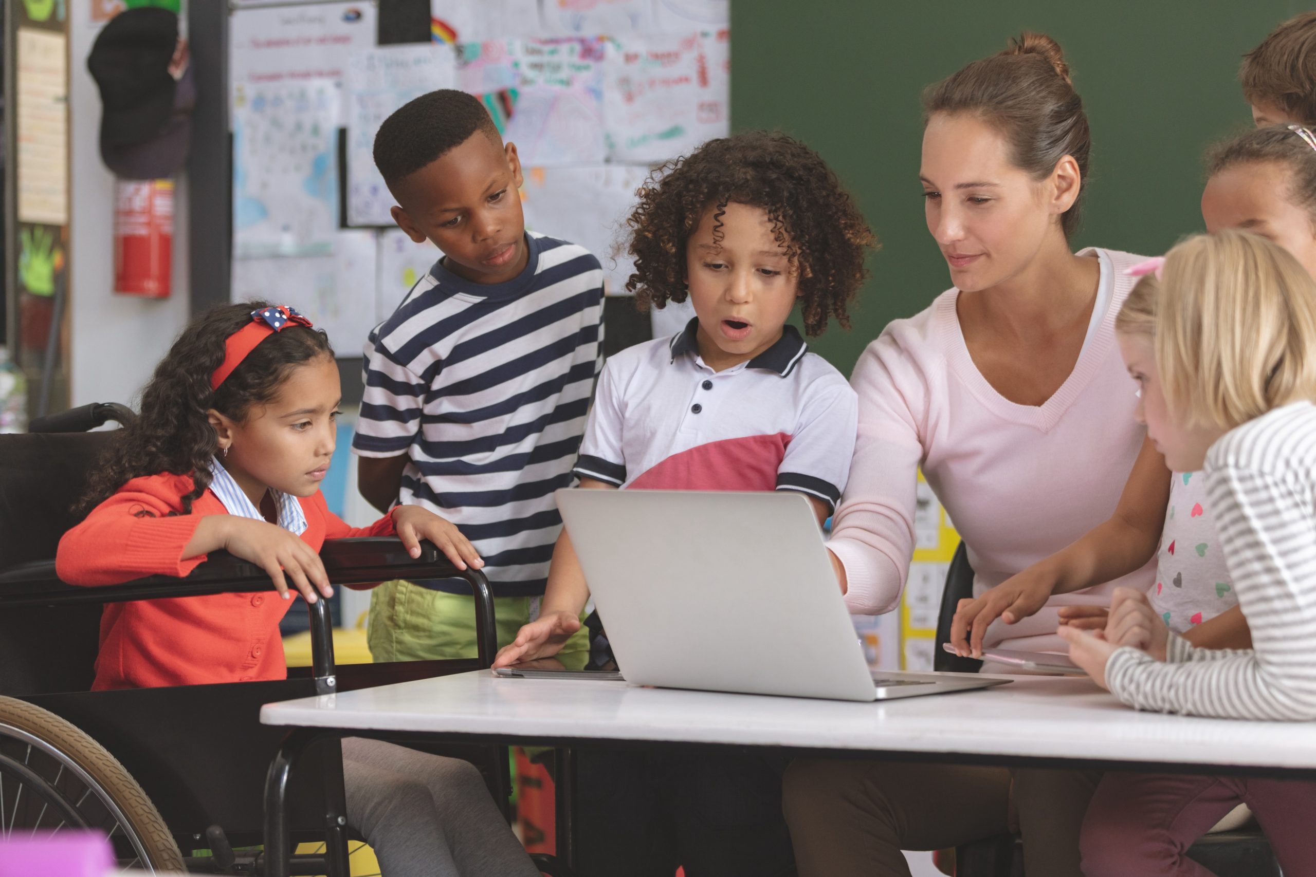 Teacher at a table with students of different physical abilities