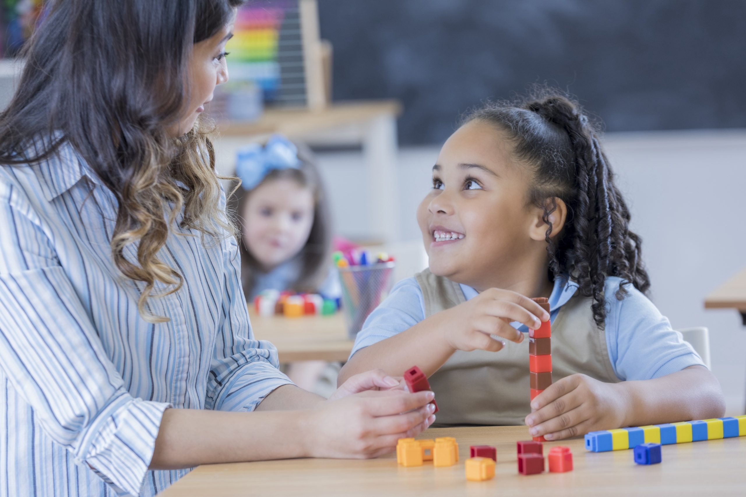 Teacher and young student in a classroom