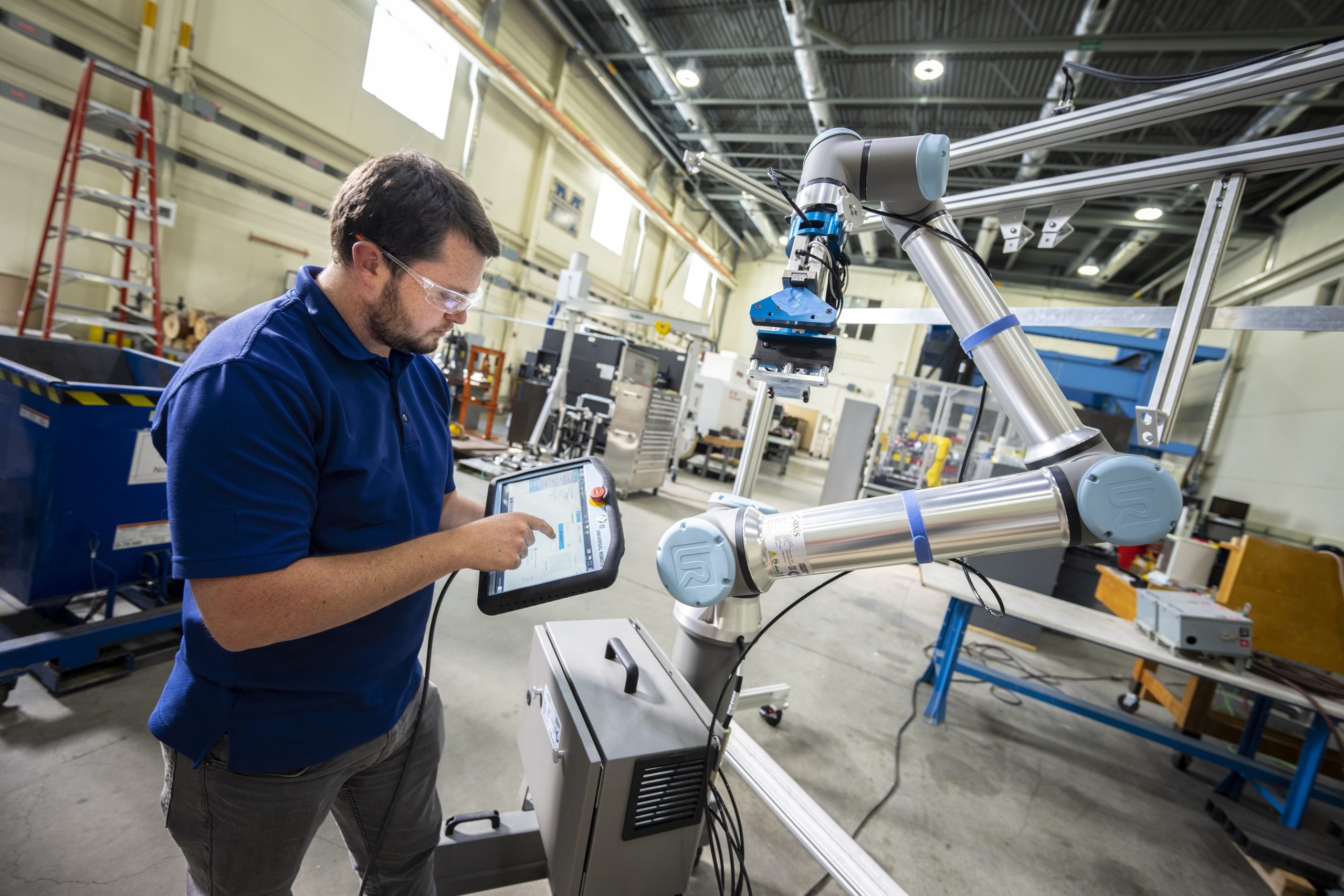 Person looking at a tablet in an engineering lab