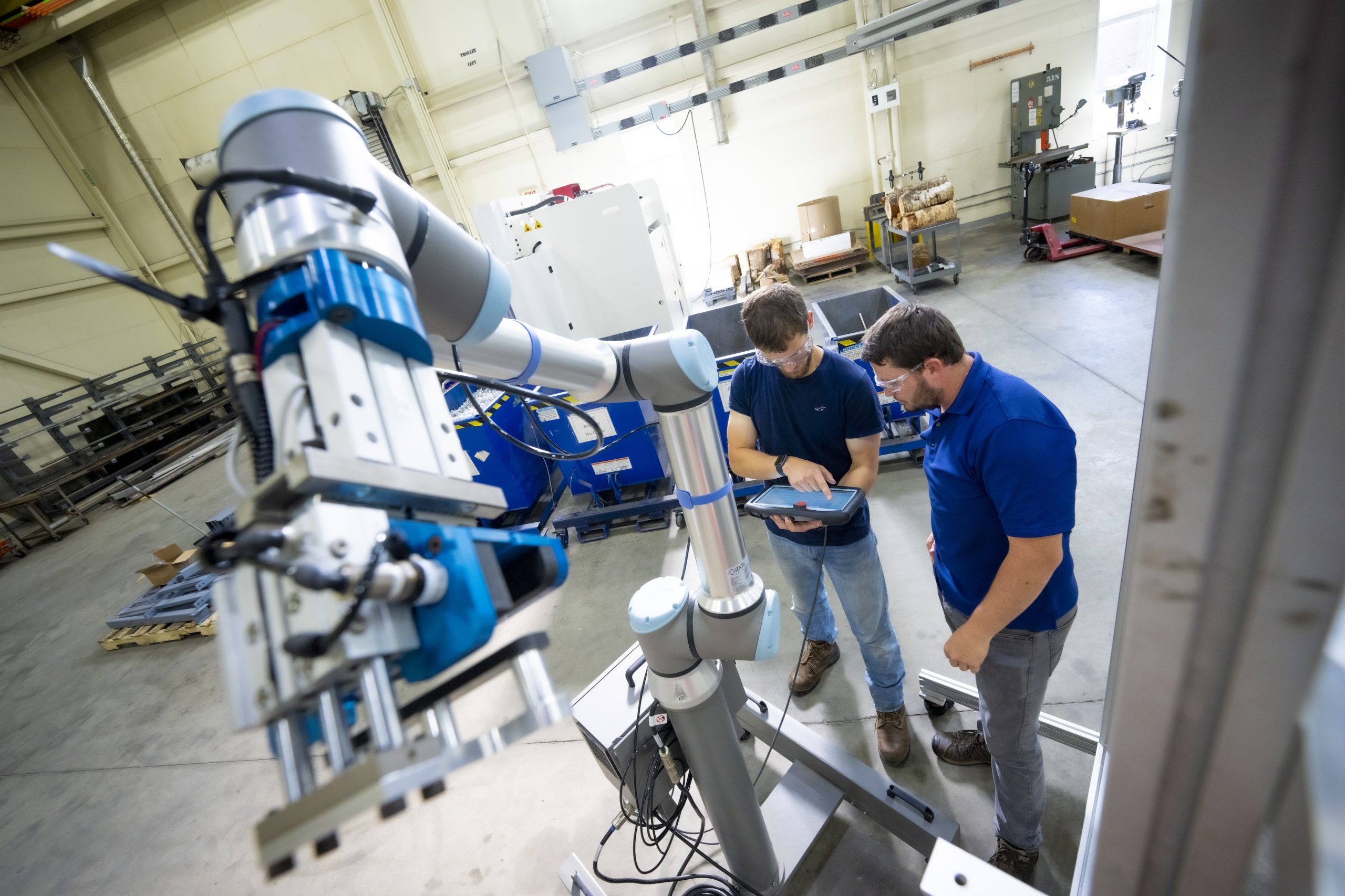 Two people looking at a tablet in an engineering lab